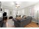 Bright living room featuring large windows, hardwood floors, and a comfortable gray sofa at 8730 Parker Pl, Roswell, GA 30076