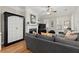 Bright living room with a fireplace, large windows with shutter blinds, and a comfortable gray sofa at 8730 Parker Pl, Roswell, GA 30076