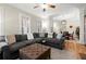 Open-concept living room featuring hardwood floors and a fireplace, adjacent to dining room at 8730 Parker Pl, Roswell, GA 30076