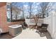 Outdoor patio area featuring two wicker chairs, a white fence, and an external air conditioning unit at 8730 Parker Pl, Roswell, GA 30076