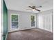 Bedroom featuring carpeting, two windows, and a closet at 115 Lake Pines Ct, Roswell, GA 30076