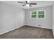 Bedroom featuring neutral walls, ceiling fan, carpet and a large window at 115 Lake Pines Ct, Roswell, GA 30076