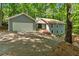 Charming two-story home with attached garage, sloping driveway, and mature trees at 115 Lake Pines Ct, Roswell, GA 30076