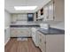 Kitchen with white appliances, cabinets, and countertops at 115 Lake Pines Ct, Roswell, GA 30076