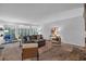 Bright and spacious living room with neutral carpet, modern furniture, and many windows at 115 Lake Pines Ct, Roswell, GA 30076