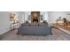 Open living room with gray sofa, fireplace, wall art, and direct access to dining space at 115 Lake Pines Ct, Roswell, GA 30076