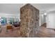 Living room with a floor-to-ceiling rock column feature, ceiling fan, and neutral decor at 115 Lake Pines Ct, Roswell, GA 30076