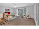 Spacious primary bedroom with a queen bed and a window to a wooded backyard at 115 Lake Pines Ct, Roswell, GA 30076
