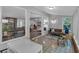 Bright sunroom with tiled floors offers views of the interior and wooded exterior at 115 Lake Pines Ct, Roswell, GA 30076