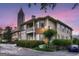 Inviting condo exterior featuring lush landscaping and a beautiful Atlanta skyline view at 200 Ne Renaissance Ne Pkwy # 304, Atlanta, GA 30308