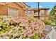 Apartment building with brick and siding exterior, surrounded by azalea bushes and partial vehicle view at 200 Ne Renaissance Ne Pkwy # 304, Atlanta, GA 30308