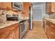 The kitchen has stainless steel appliances, wooden cabinets, and granite countertops at 200 Ne Renaissance Ne Pkwy # 304, Atlanta, GA 30308