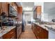 Galley-style kitchen featuring granite countertops, stainless steel appliances, and wood cabinetry at 200 Ne Renaissance Ne Pkwy # 304, Atlanta, GA 30308