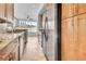 Modern kitchen features stainless steel appliances, wood cabinetry, stone countertops, and wood floors at 200 Ne Renaissance Ne Pkwy # 304, Atlanta, GA 30308