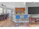 Living room with a modern kitchen and bar stools, dark hardwood floors, and an open concept at 200 Ne Renaissance Ne Pkwy # 304, Atlanta, GA 30308