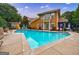 A large community pool surrounded by lounge chairs and greenery at 200 Ne Renaissance Ne Pkwy # 304, Atlanta, GA 30308