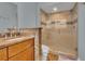 A well-lit bathroom with a glass-enclosed shower featuring neutral tile and granite vanity at 200 Renaissance Ne Pkwy # 304, Atlanta, GA 30308