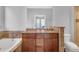 Luxurious bathroom with double vanity, a soaking tub, tile floors and a private toilet area at 200 Renaissance Ne Pkwy # 304, Atlanta, GA 30308