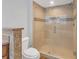 Bathroom featuring glass enclosed shower, tiled walls and floors, and updated fixtures at 200 Renaissance Ne Pkwy # 304, Atlanta, GA 30308