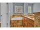 Well-lit bathroom showcasing tiled floors and walls, a double sink, and a soaking tub under a window at 200 Renaissance Ne Pkwy # 304, Atlanta, GA 30308