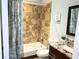 Bathroom showcasing a tub and shower with neutral colored tiling, a modern vanity, and a mirror at 200 Renaissance Ne Pkwy # 304, Atlanta, GA 30308