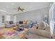 Spacious living room featuring neutral walls, stylish furnishings, and a ceiling fan at 200 Renaissance Ne Pkwy # 304, Atlanta, GA 30308