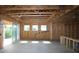 Interior view of a second story framing with large window overlooking the back yard at 214 Wild Ginger Bnd, Woodstock, GA 30188
