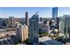 An aerial view of a high-rise building in a bustling city, featuring modern architecture and clear blue skies at 3338 Peachtree Ne Rd # 3406, Atlanta, GA 30326