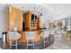 Light and bright bar area with barstools, wood paneling, shelving, recessed lighting, and a doorway leading to an outdoor area at 3338 Peachtree Ne Rd # 3406, Atlanta, GA 30326