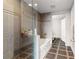 Bathroom featuring tiled walls, glass shower door, and separate bathtub at 3338 Peachtree Ne Rd # 3406, Atlanta, GA 30326