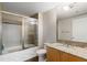 Well-lit bathroom with granite counters, and a tub-shower combo with glass doors at 3338 Peachtree Ne Rd # 3406, Atlanta, GA 30326