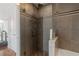 Bathroom featuring tiled walls, glass shower door, and separate bathtub at 3338 Peachtree Ne Rd # 3406, Atlanta, GA 30326