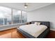 Bedroom with hardwood floors, ceiling fan, large windows, and stunning city views at 3338 Peachtree Ne Rd # 3406, Atlanta, GA 30326
