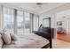 Bedroom featuring a dark wood dresser, balcony access and floor to ceiling window views at 3338 Peachtree Ne Rd # 3406, Atlanta, GA 30326