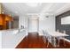 Bright dining area with modern table, open to the kitchen, and hardwood floors at 3338 Peachtree Ne Rd # 3406, Atlanta, GA 30326