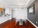 Dining area with modern table, hardwood floors, and decorative mirror adjacent to kitchen at 3338 Peachtree Ne Rd # 3406, Atlanta, GA 30326