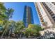 Modern high-rise building with balconies, nestled among trees and city views at 3338 Peachtree Ne Rd # 3406, Atlanta, GA 30326