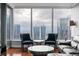 Living room features hardwood floors, and floor to ceiling windows with a panoramic city view at 3338 Peachtree Ne Rd # 3406, Atlanta, GA 30326