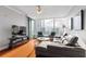 Modern living room with expansive windows, city views, hardwood floors, and sleek furniture at 3338 Peachtree Ne Rd # 3406, Atlanta, GA 30326