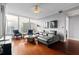 Bright living room features large windows, hardwood floors, comfortable seating, and city views at 3338 Peachtree Ne Rd # 3406, Atlanta, GA 30326