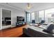 Bright living room with large windows, city views, hardwood floors, and inviting seating at 3338 Peachtree Ne Rd # 3406, Atlanta, GA 30326