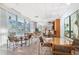 Bright lounge area with floor to ceiling windows, tables, chairs, bar area, and artwork at 3338 Peachtree Ne Rd # 3406, Atlanta, GA 30326