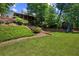 Beautiful backyard with lawn, landscaping, patio, playset, and view of the house at 3912 Edenton Ne Ct, Brookhaven, GA 30319