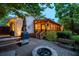 Backyard with a deck, fire pit, stone patio, and lush landscaping, creating a peaceful outdoor retreat at 3912 Edenton Ne Ct, Brookhaven, GA 30319