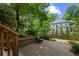 Backyard patio with brickwork, chair, and view of lawn, landscaping, and house at 3912 Edenton Ne Ct, Brookhaven, GA 30319