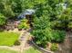 Serene backyard featuring lush greenery, stone steps, fire pit, and multiple seating areas at 3912 Edenton Ne Ct, Brookhaven, GA 30319