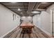 Partially finished basement with exposed ceiling, laminate flooring, and space for recreation at 3912 Edenton Ne Ct, Brookhaven, GA 30319