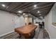 Partially finished basement space featuring a billiards table with ping pong conversion top, exercise equipment, and ample storage at 3912 Edenton Ne Ct, Brookhaven, GA 30319