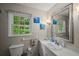 Bright bathroom featuring a large mirror, a single sink vanity, and natural light at 3912 Edenton Ne Ct, Brookhaven, GA 30319