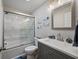 Modern bathroom featuring glass enclosed shower, sleek vanity with grey cabinets, and decorative accents at 3912 Edenton Ne Ct, Brookhaven, GA 30319